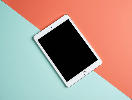 Tablet computer with blank screen on colorful background. Flat lay.の素材