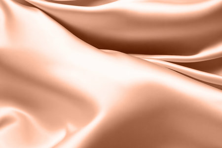 Abstract background, folds of silk fabric in peach fuzz color. AI generated.の素材