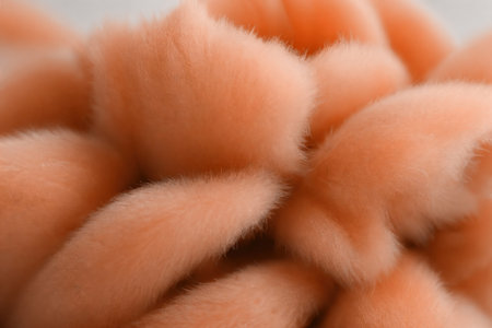 Small balls of wool, the color of peach fuzz. AI generated.の素材
