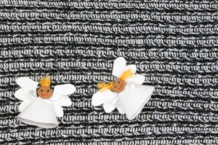 Two cheerful paper angel on monochrome backgroundの写真素材