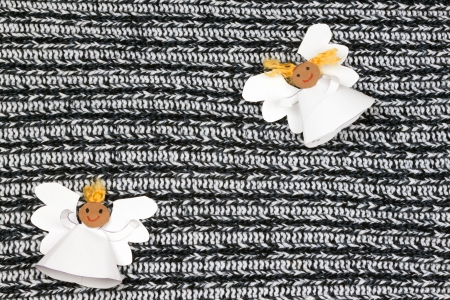 Two cheerful paper angel on monochrome backgroundの写真素材