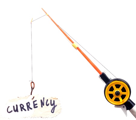 fishing rod with a hook on wearing the piece of paper with the word "currency"の写真素材