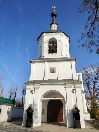 An old Russian church exterior over a blue sky on a bright sunny dayの写真素材