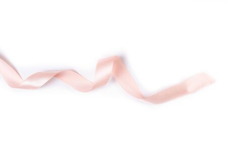 beige, pink satin ribbon isolated on white backgroundの写真素材
