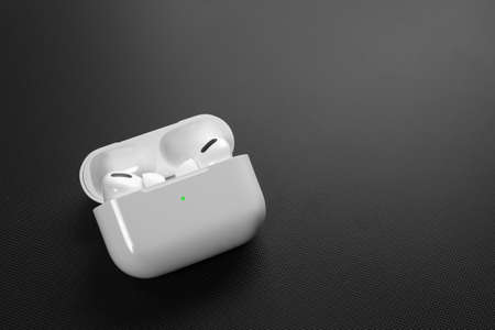 Air Pods Pro. with Wireless Charging Case. New Airpods pro on black background. Airpods Pro. Copy...