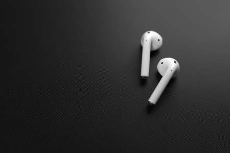 Air Pods. with Wireless Charging Case. New Airpods 2019 on black background. Airpods. Copy space.のeditorial素材