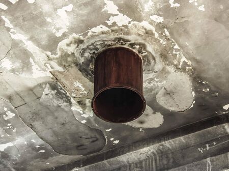 huge rusty pipe. old concrete walls. ruins of the Soviet Union.