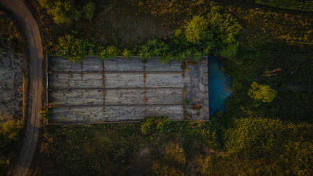 a concrete dam in the middle of endless fields