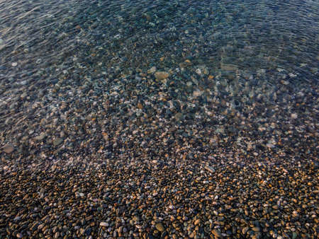 clean sea water beach covered with pebbles black sea. Adler. High quality photo