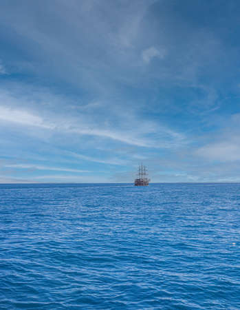 a boat on the horizon of the Mediterranean sea.