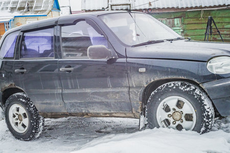 rural old SUV in the yard in winter.の写真素材
