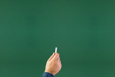 Blank blackboard / chalkboard, hand writing on green chalk board holding chalkの写真素材