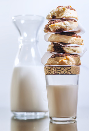 Sweet cinnamon rolls stacked on a milk glassの写真素材