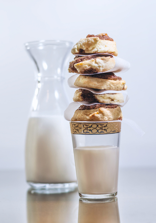 Sweet cinnamon rolls stacked on a milk glassの写真素材