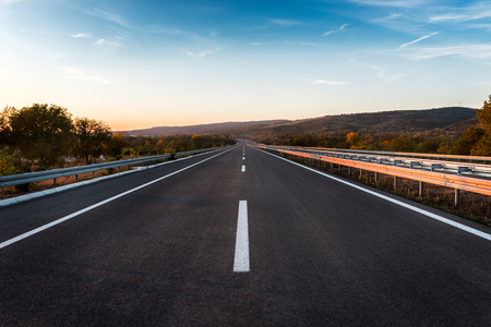 Empty Highway road with markings at sunsetの写真素材