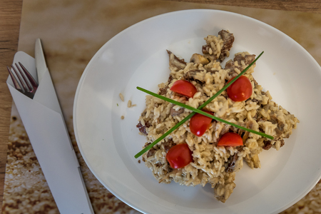 Risotto with Beef and Mushrooms on a Restaurant Wooden Table with utensils and spicesの写真素材