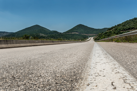 Motorway or Highway winding among hills through a rural landscapeの写真素材