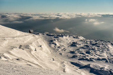 Lonely Cottage high in the Mountain in a snowy Winter Landscape, Mountain Kopaonik, Serbiaの写真素材