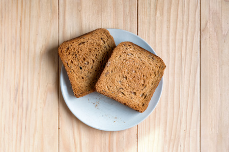 Two Slices of Toast Bread on a Wooden Table Setupの写真素材