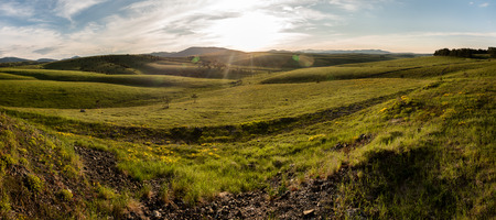 Landscape panorama of Zlatibor Mountain. Green meadows and hills under blue sky with clouds in springtimeの写真素材