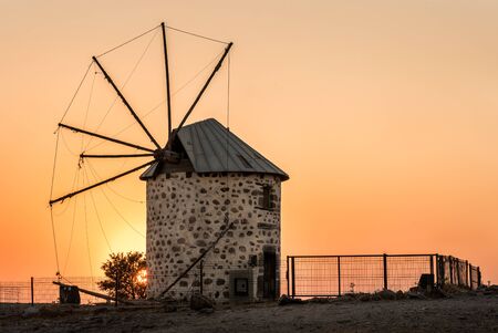 Ancient old windmill at sunset on the hill in the city of Bodrum in Turkeyの写真素材