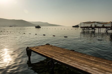 Panoramic Sunrise view of Bodrum Castle and marina bay on Turkish Riviera from old wooden docks. Bodrum is a district and a port city in Mugla Province, in Aegean Region of Turkeyの写真素材
