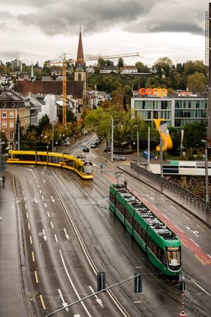 Basel, Switzerland - November 03, 2019: Perspective view of downtown traffic with Trams and cars on...
