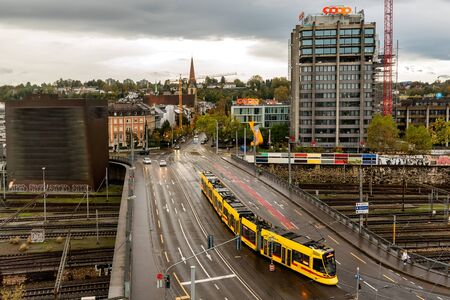 Basel, Switzerland - November 03, 2019: Perspective view of downtown traffic with Trams and cars on...
