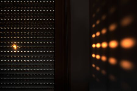Shutters - blinds with sunlight in the morning. Dark wooden window with blinds. Interior abstract design of living room with window horizontal blinds. Soft focus abstract backgroundの写真素材