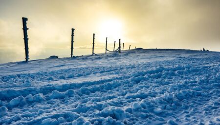 Fence poles in heavy fog and snow in winter, Mountain Kopaonik, Serbia
