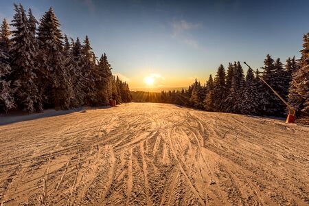 View of a ski resort piste at sunset on mount Kopaonik, Serbiaの写真素材