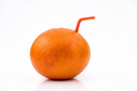 Isolated Grapefruit juice. A whole Red Grapefruit with orange straw, concept of natural fresh fruit juice isolated on white backgroundの写真素材