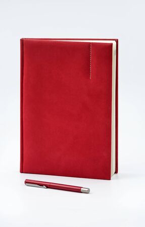 Red Notebook & Red Pen isolated on white background. Business concept. Business people items. Free space for text.の写真素材