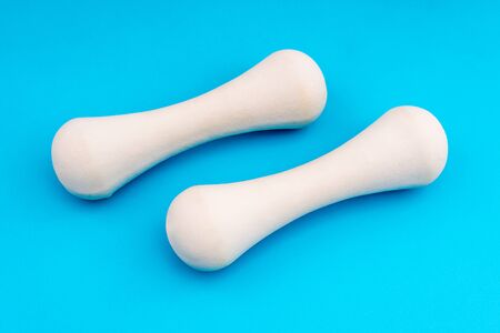White Dumbbells on blue background top view with copy space. Fitness concept. Fitness background, healthy lifestyle.の写真素材