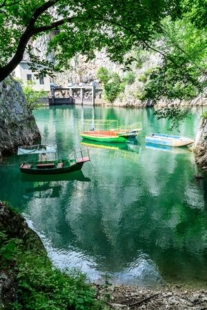Old rugged and colorful boats docked in the small bay at Matka Canyon, Skopje, Macedoniaの写真素材