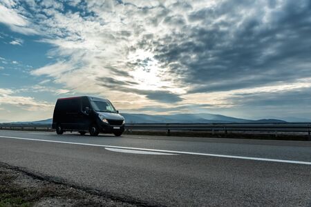 Delivery van on the highway road at sunset. Transports, logistics conceptの写真素材