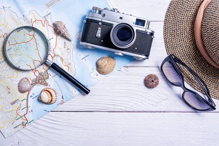 Top view of planning vacation planning using a map, magnifier, retro camera - Travel influencer looking for the next travel destination - Concept of adventure, tourism, and traveling people lifestyleの写真素材