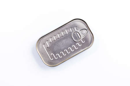 Canned fish in sealed oval tin can with easy openable lid on a white background - top viewの写真素材