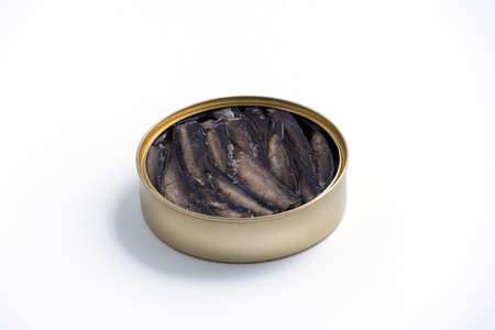 Smoked sprats in cooking oil in the open tin can isolated on white backgroundの写真素材