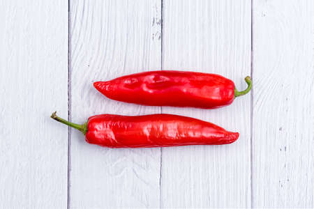 Red chili peppers on white wooden table. Spice for cooking menu in kitchenの写真素材