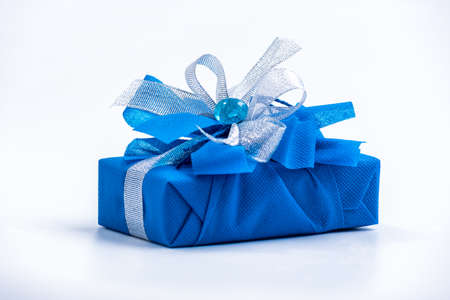 Classic blue surprise gift box with blue and white ribbon, background with copy spaceの写真素材