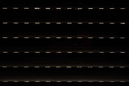 Shutters - blinds with sunlight in the morning. Dark wooden window with blinds. Interior abstract design of living room with window horizontal blinds. Soft focus abstract backgroundの写真素材