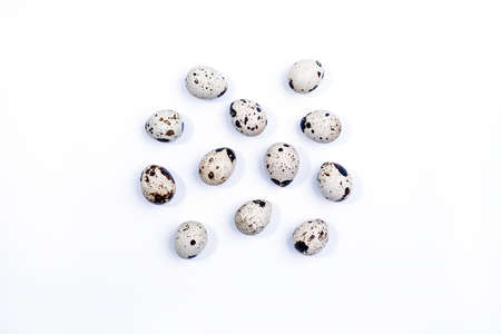 Quail eggs isolated on white background. Group of quail eggs close-up isolated on a white background. Top view. Detailed closeup of spotted quail eggsの写真素材