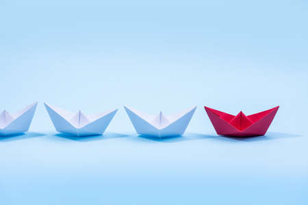 Red and white paper boats. Concept of leadership boats for teamwork group or success.の写真素材