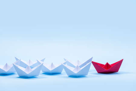 Red and white paper boats. Concept of leadership boats for teamwork group or success.の写真素材