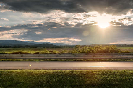 Empty highway asphalt road and beautiful sky sunset landscape. Landscape scene and sunrise above roadの写真素材