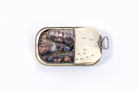 Closeup of an open can of sardines isolated on white background. Canned sardine.の写真素材