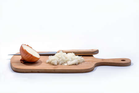 Chopped and half onion on a wooden cutting board isolated on white backgroundの写真素材