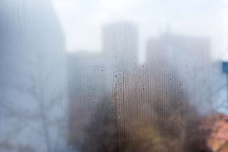 Foggy Window with condensate or steam after heavy rain, large texture or background. Wet misted...