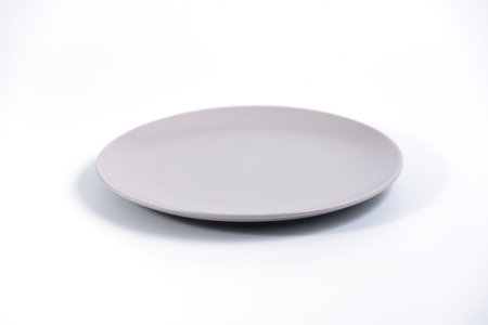 Empty Gray plate isolated on white background side view, selective focusの写真素材